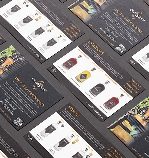 Old Salt Distillery menu cards fanned out on a dark surface