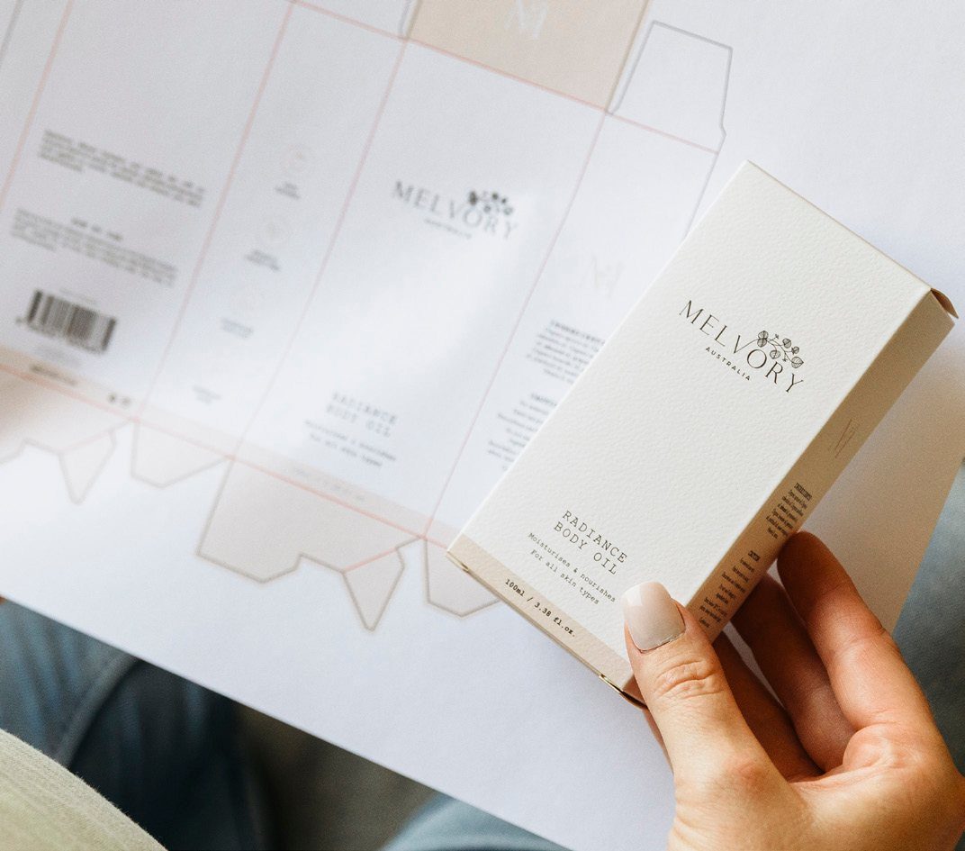 Melvory packaging and swing tags laid out on a desk
