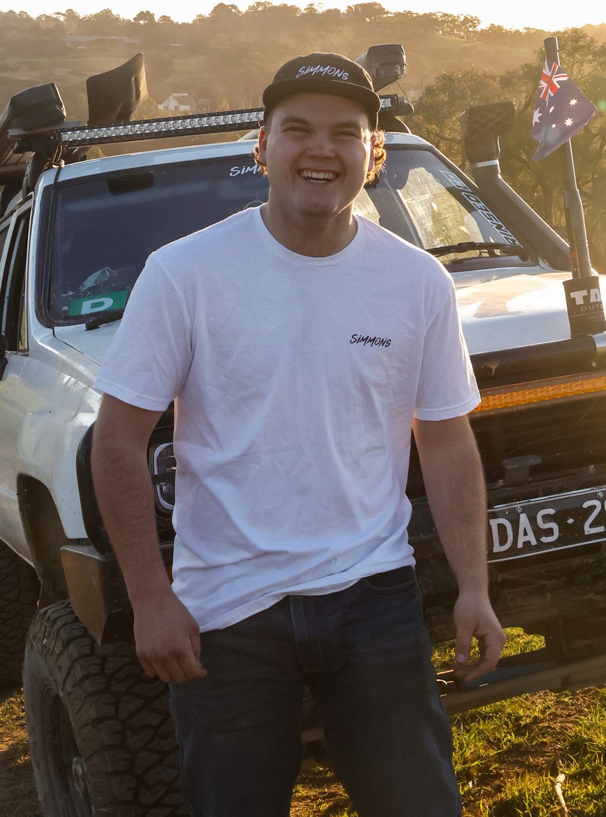 Boyd standing in front of a four-wheel drive at sunset